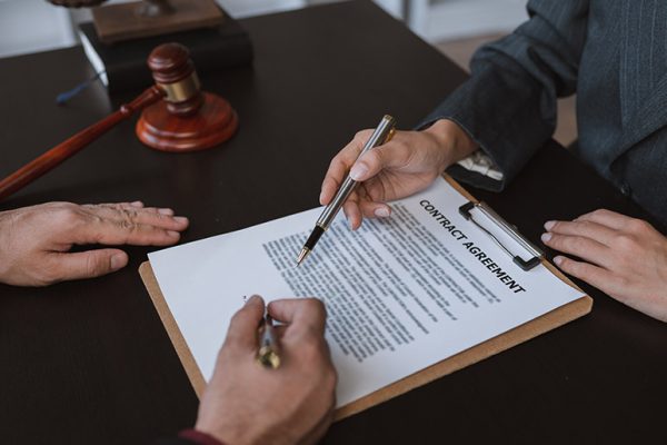 businessmen-and-lawyers-discuss-and-read-the-detai-6SW59CN