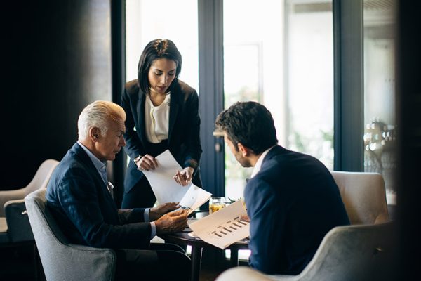 businesswoman-and-men-having-meeting-in-hotel-rest-H4CES84